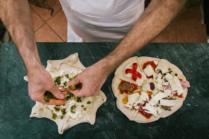 Attlio Bachetti (56) prepares (L-R) a Pizza Appennini (with ricotta, provola and zucchini) and a Pizza Attilio (with 9 flavors), here at the Pizzeria Trattoria da Attilio in Naples. Photos by Gianni Cipriano