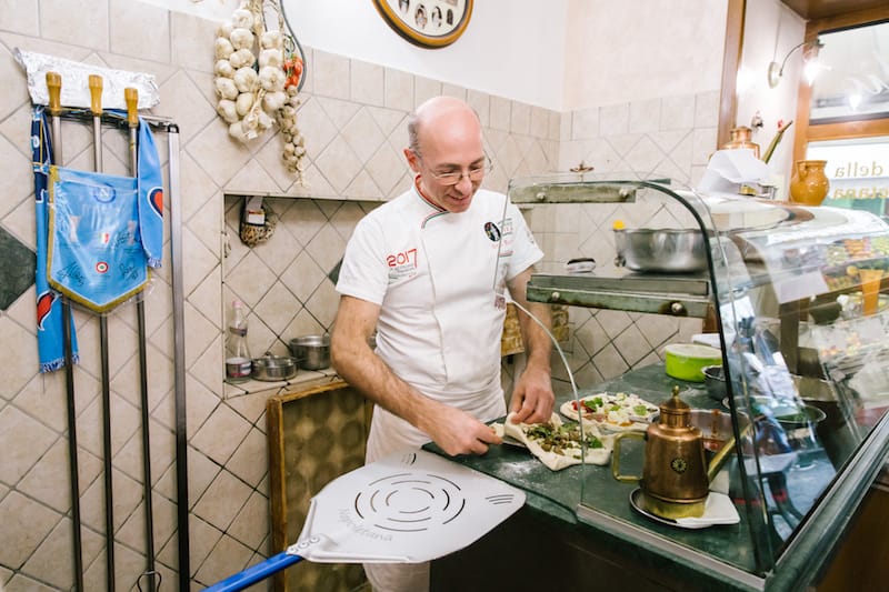 Attlio Bachetti (56) prepares (L-R) a Pizza Appennini (with ricotta, provola and zucchini) and a Pizza Attilio (with 9 flavors), here at the Pizzeria Trattoria da Attilio in Naples. Photos by Gianni Cipriano