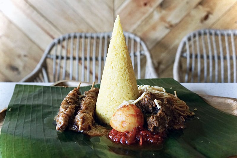 Nasi kuning, a traditional celebratory dish made with turmeric rice, photo by Fiona Chandra