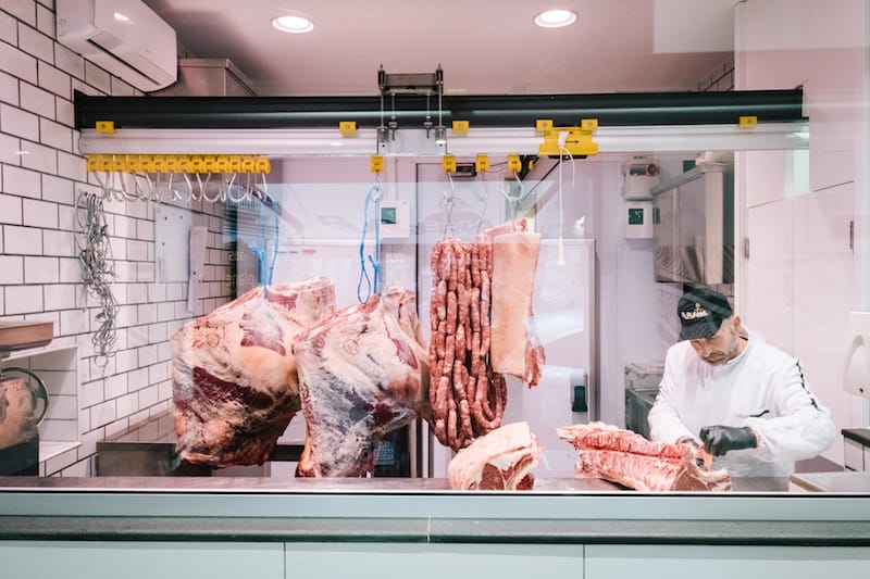 NAPLES, ITALY - 30 MAY 2019: A butcher is seen here at work at D'Ausilio, a butcher shop in Naples, Italy, on May 30th 2019.<br /> Raffaele D’Ausilio comes from a family of butchers. His grandfather, Alfredo d’Ausilio, opened a butcher shop in 1947. All four of his children became butchers, including Raffaele’s father Vincenzo. In the early 2000s, Raffaele and his wife Roberta took over the family business with their touch of innovation: a butcher shop during the day, a take-away burger shop at night.