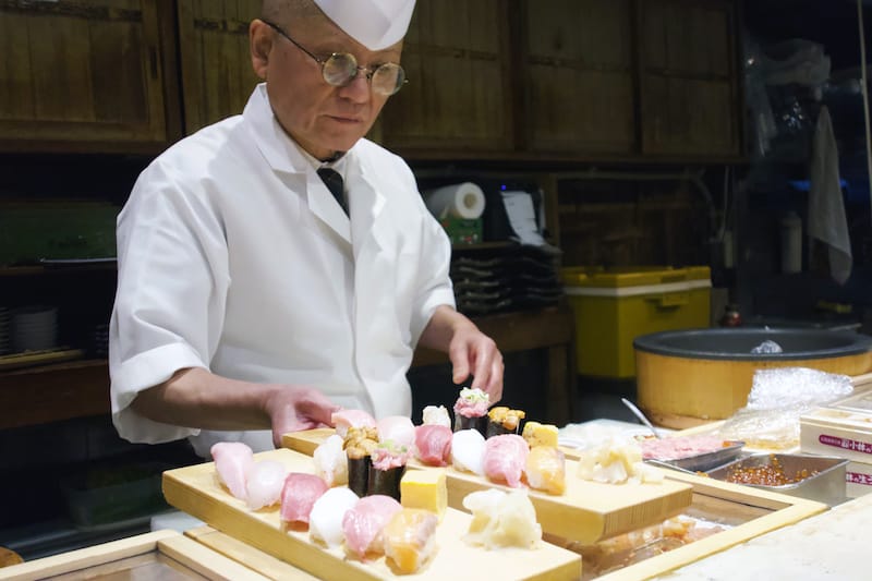 Preparing sushi at Tsukiji Itadori Bekkan, photo by Fran Kuzui