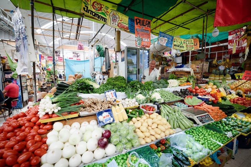 Rafa spends most days on an elevated platform in the center of his vegetable pyramid admiring his wares, photo by PJ Rountree Rafael Hernandez, known as El Negrito