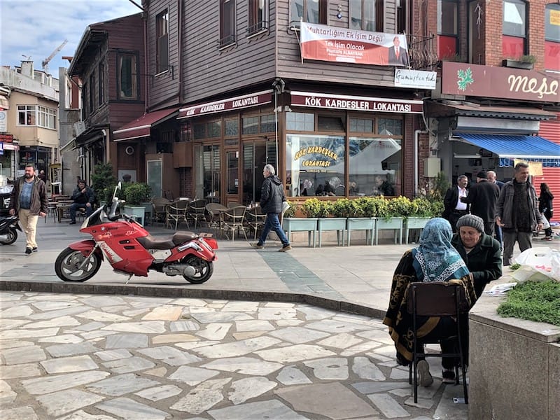 From above, we watched the square, where old men looked out at the water, kids fed the pigeons, ladies chatted under the trees and a brand-new red motorcycle sat parked in the middle of the yard. Photo by Lorenza Mussini