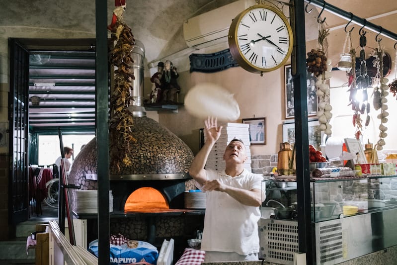 Beppe Sica tosses pizza dough, photo by Gianni Cipriano and Sara Smarrazzo