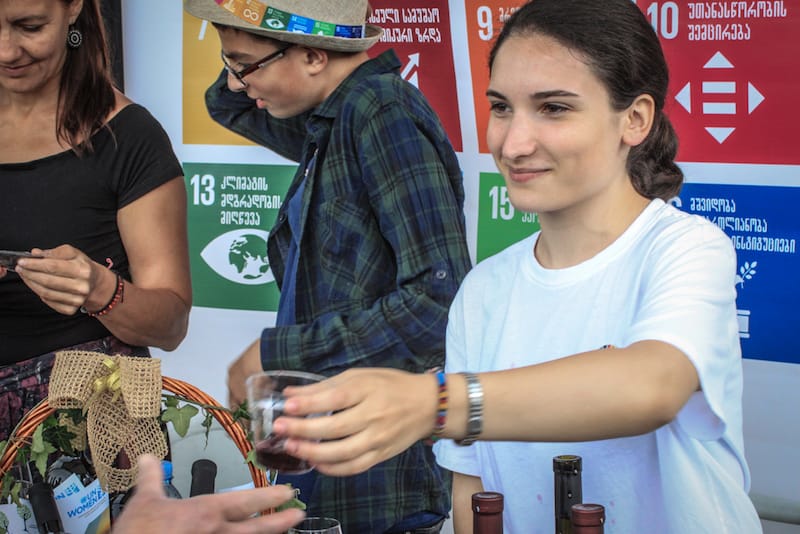 Mariam Margvalidze pours her Khvanchkara at a local festival in Ambrolauri, Racha, photo by Paul Rimple Racha wine, photo by Paul Rimple