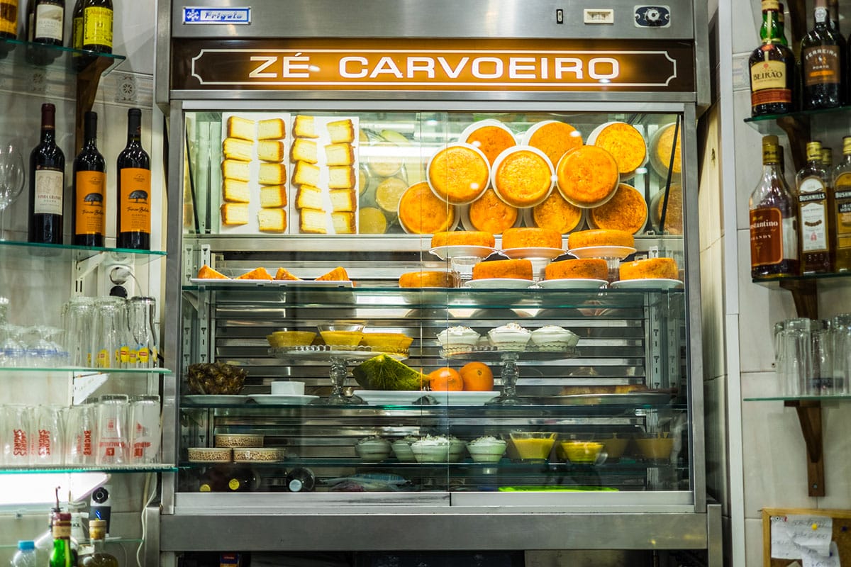 Get up close to a classic tasca dessert case, an essential element of Lisbon culinary culture