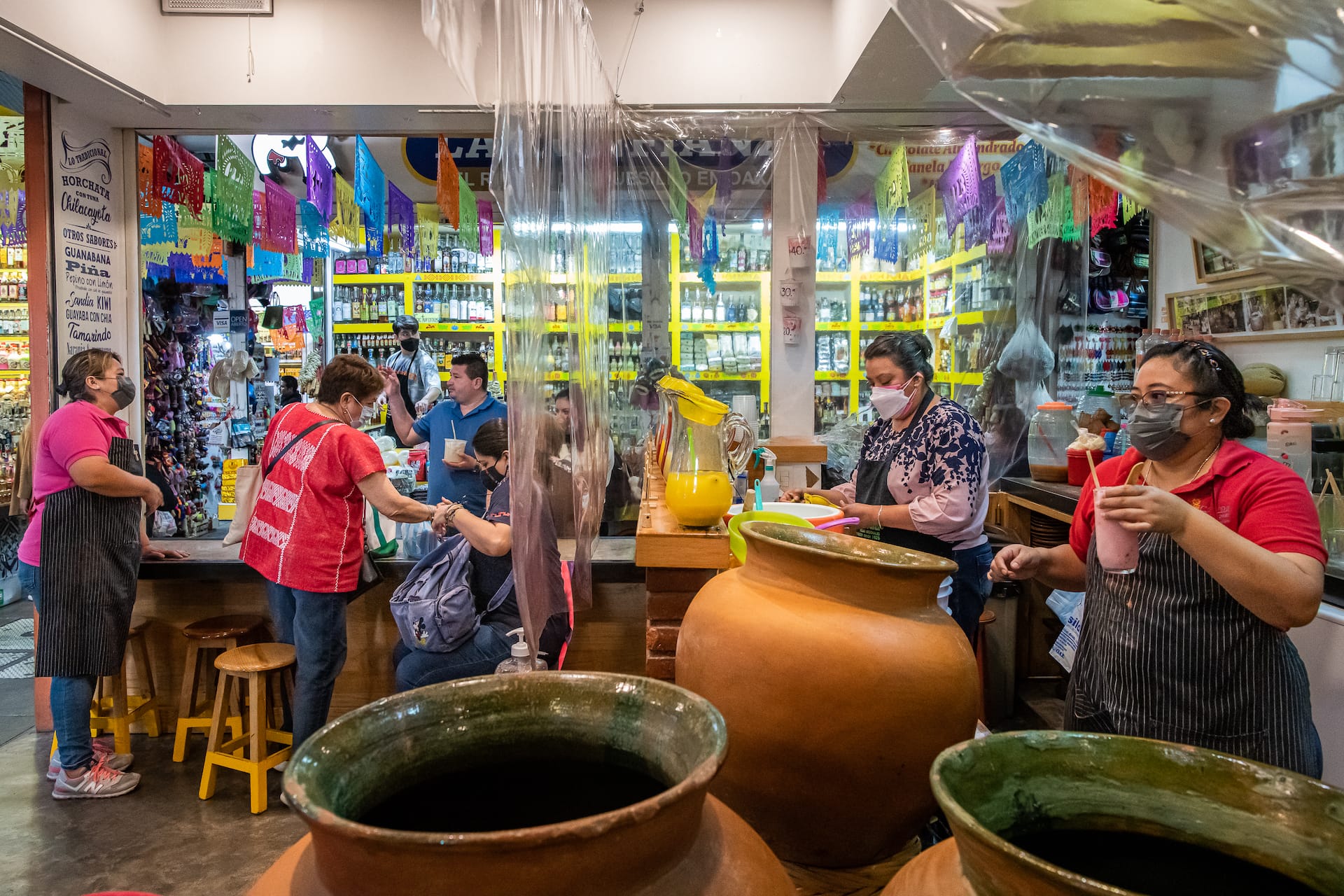 serving drinks from large clay pots