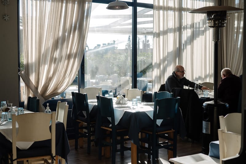 The attractive, spacious dining area at Porphya is the site of a former police station, photo by Manteau Stam