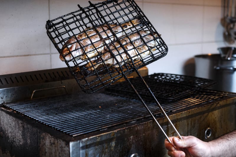 Grilling fish at Porphyra, photo by Manteau Stam