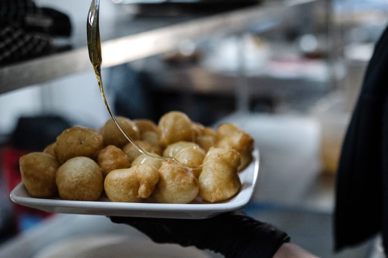 A mound of perfectly fried loukoumades (doughnut puffs with honey), generally offered on the house at Porphyra, photo by Manteau Stam