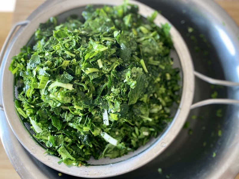Straining water from the greens, photo by Carolina Doriti