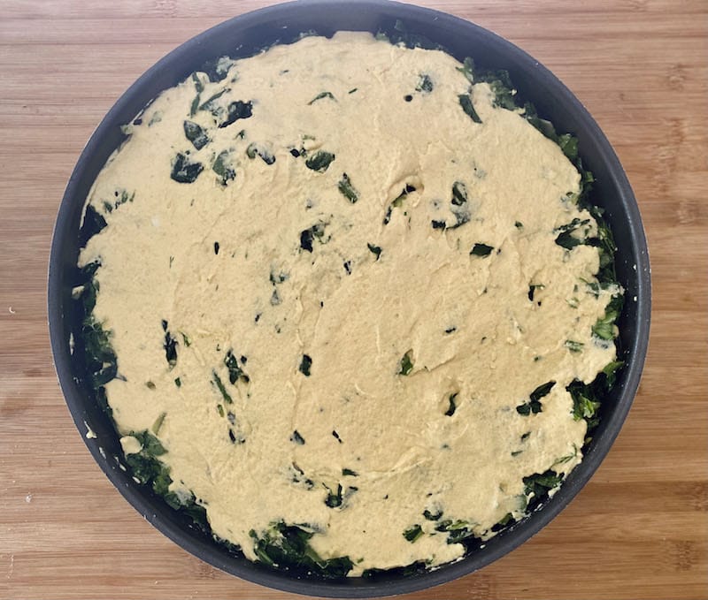 After spreading the final layer of the porridge-like mixture on top but before sprinkling sesame seeds, photo by Carolina Doriti