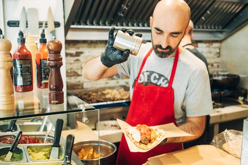 Putting the final touches on a vegan souvlaki at Cookoomela Grill, photo by Marco Arguello
