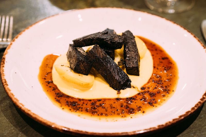Beef spare ribs coated in vegetable ash and served with baby potatoes and black truffle sauce at Farma Bralou, photo by Marco Arguello farm to table best restaurants athens