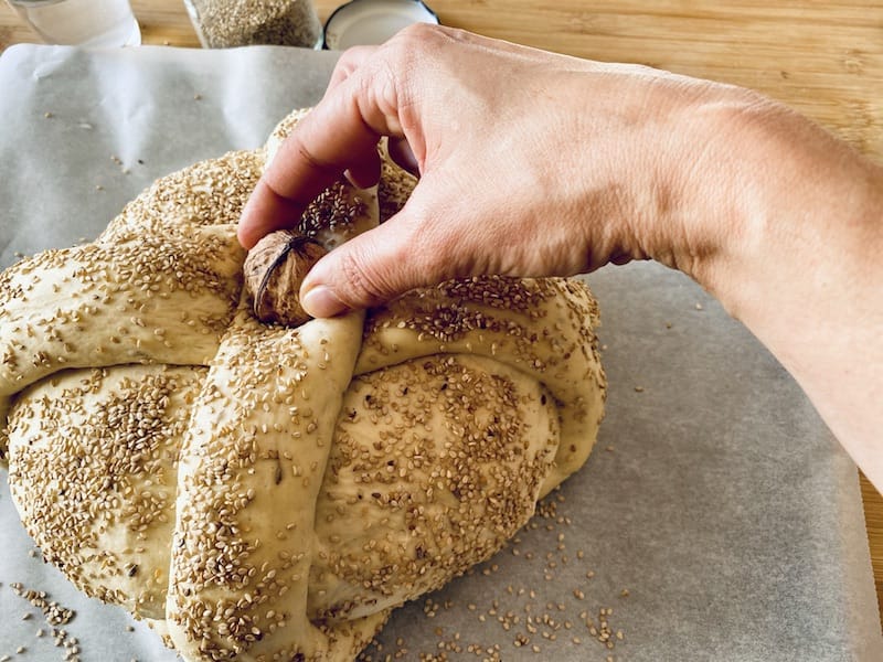 Christopsomo is most commonly covered in sesame seeds and decorated with a big cross that has a shelled walnut at its center, photo by Carolina Doriti
