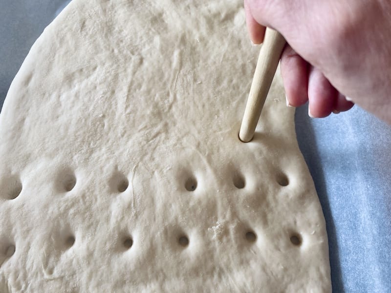 Pressing down on the dough to create lagana’s typical design, photo by Carolina Doriti