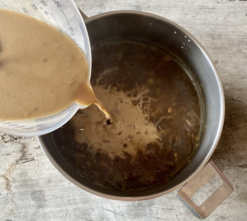 Pouring tahini into the hot soup, photo by Carolina Doriti Tahinosoupa