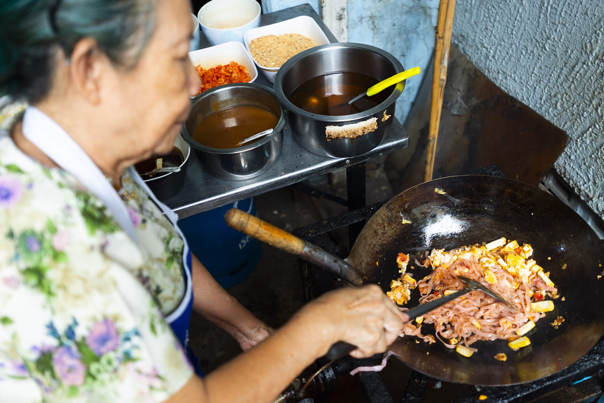 two Thai dishes on a pink tablecloth in Bangkok