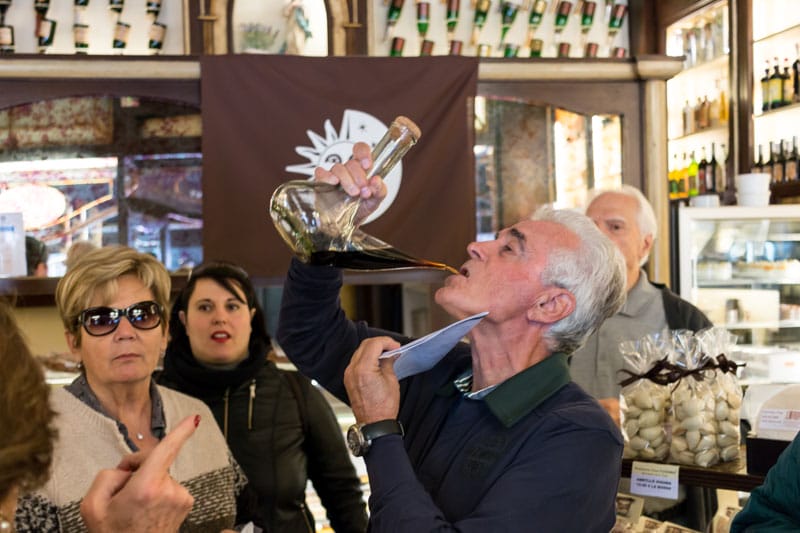 Drinking ratafia from a porron at Casa Tuyarro, photo by Sam Zucker