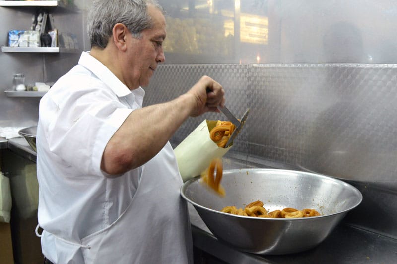 Manuel San Román making churros, photo by Paula Mourenza