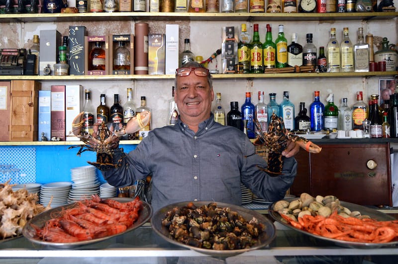 man showing off an array of seafood