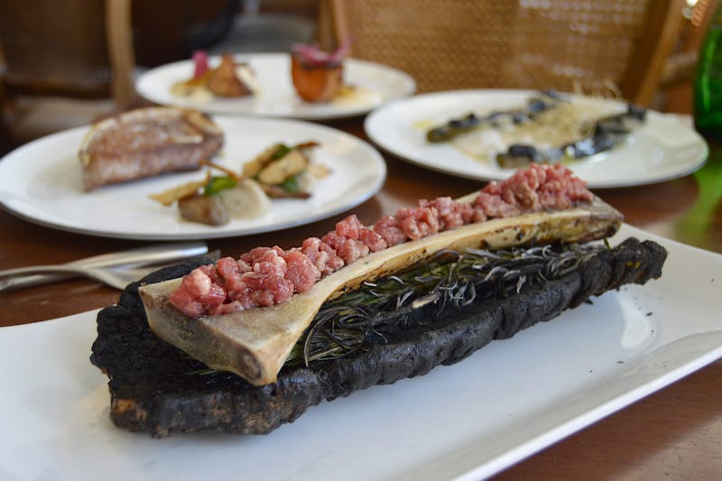 Beef marrow served inside the bone and covered with raw mince, photo by Paula Mourenza