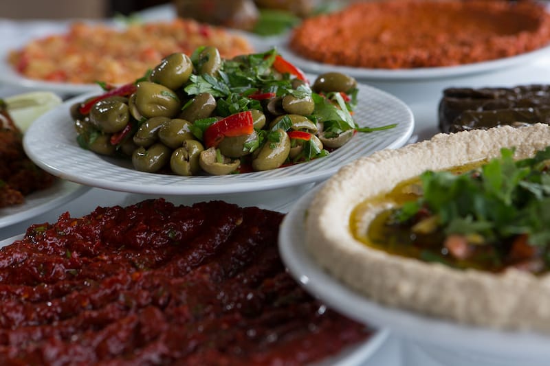 A meal of Hatay meze: muhammara, hummus and cracked olive salad with pomegranate molasses, photo by David Hagerman