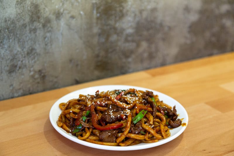 Dana etli makana, thick and chewy lagman flash-fried with beef and peppers and coated with a spicy, semi-sweet glaze, photo by Bradley Secker