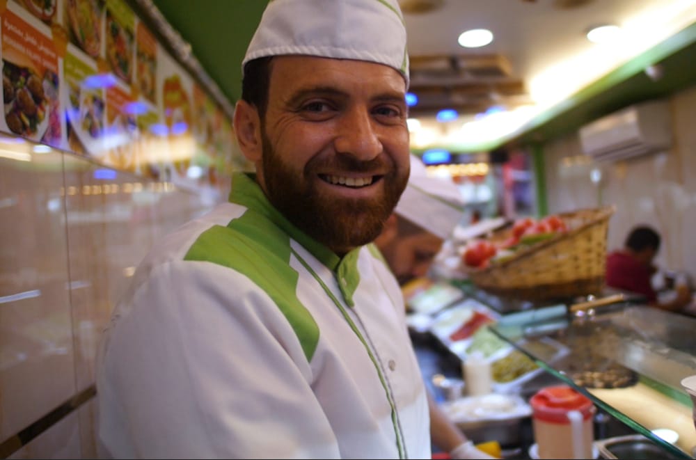One of the staff members at Gaza Falafel, a still from “Meet Me in Yusufpaşa,” a film by Tara Milutis