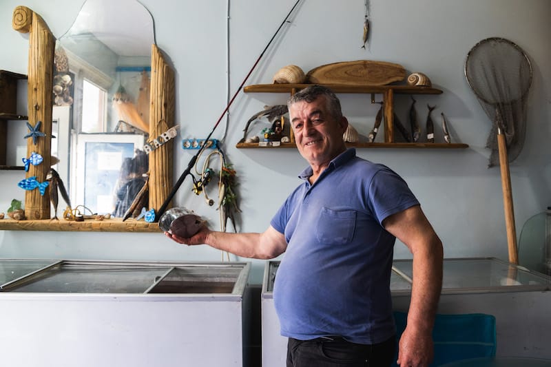 Ahmet holds up some of his lakerda at Rumeli Kavağı Lakerda Balık Şarküteri, photo by Alex Indra