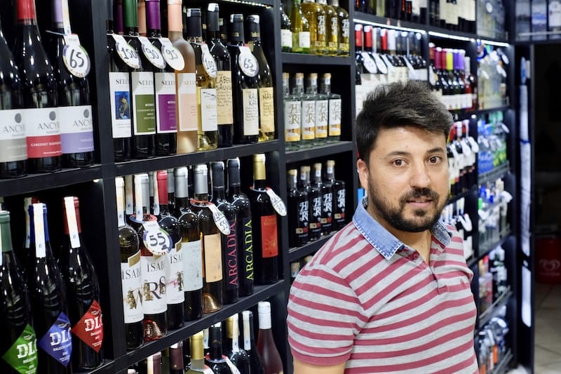 Muhammet Çelebi in Gözde Tekel, the tiny wine shop he owns with his brother in Kurtuluş, photo by Paul Benjamin Osterlund