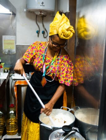 Carol Alves de Brito “whipping” a mix of processed black eye peas, salt and garlic, Acarajé da Carol, Lisbon, photo by Austin Bush