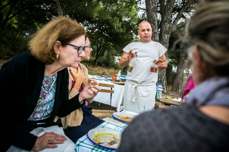 Chef Filipe Rodrigues holding bottles of garum, photo by Rodrigo Cabrita
