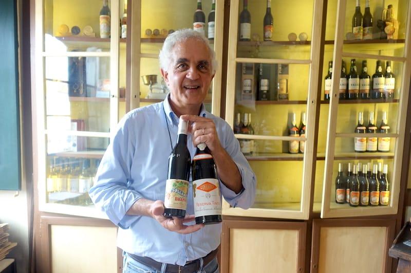 José Baeta, owner of Adega Viúva Gomes, holds some bottles from their cellar, photo by Ansel Mullins colares wine