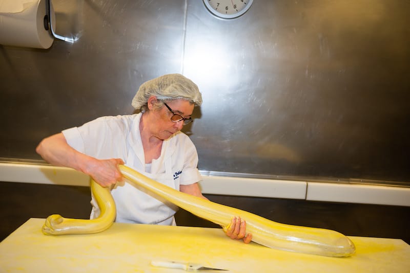 An employee shapes laminated pastry into cups, Pastéis de Belém, photo by Austin Bush