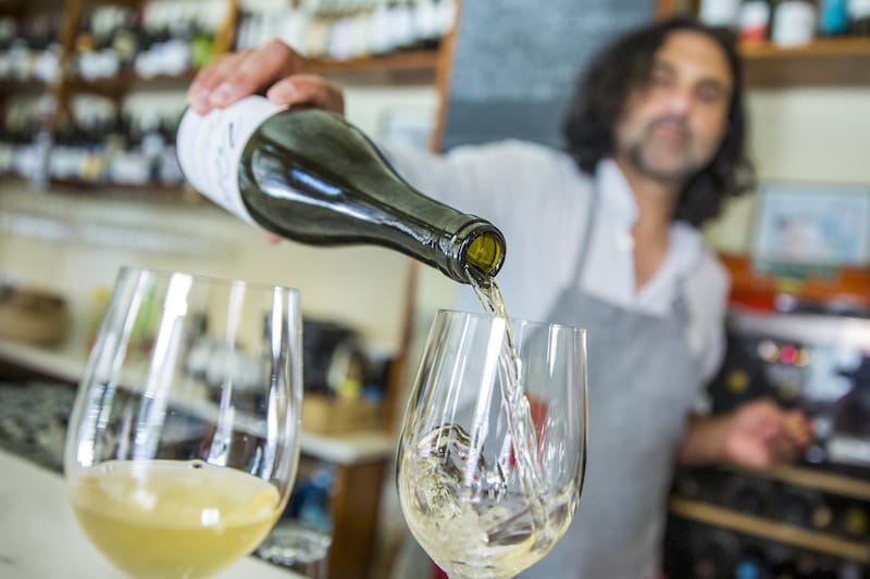 Ramón Ibáñez pours a glass of natural wine at Tati in Lisbon, photo by Rodrigo Cabrita