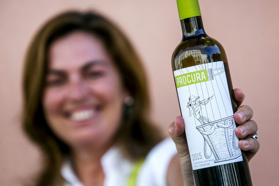 Susana Esteban holding a bottle of her Procura white wine, photo by Rodrigo Cabrita