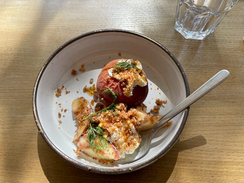 A dessert of roasted peach and nectarines, whipped cream with almond and crumble, photo by Annie Etheridge