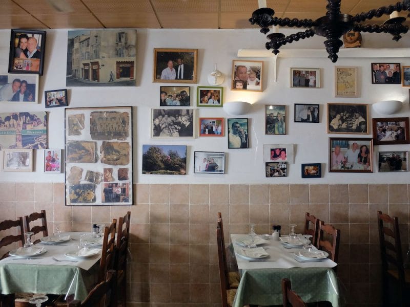 The walls at Chez Etienne are lined wiht historic photos of famous customers, photo by Alexis Steinman