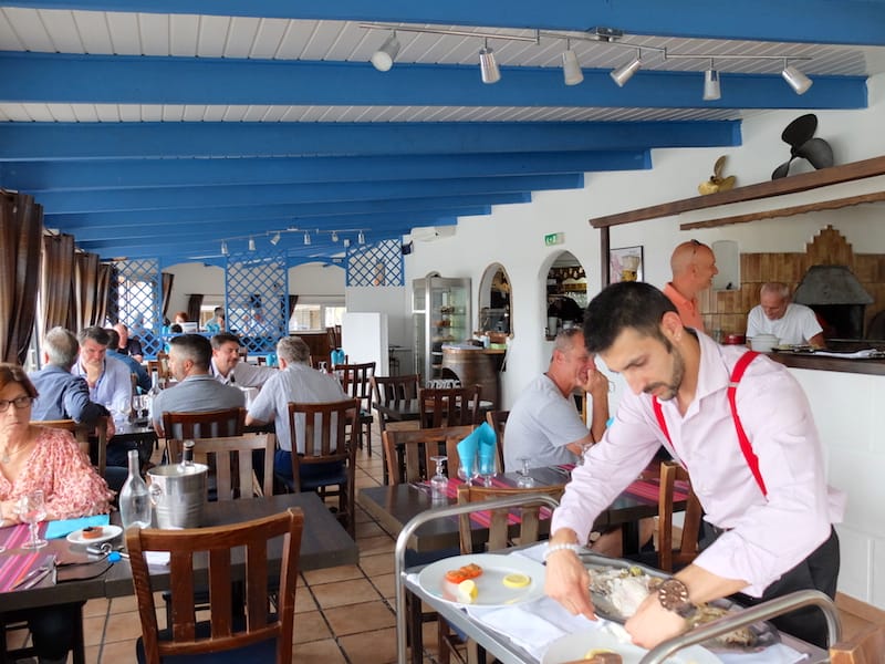 Hippocampe's white-washed ceiling and nautical blue trim evoke the interior of the old boats that bob beside it, photo by Alexis Steinman