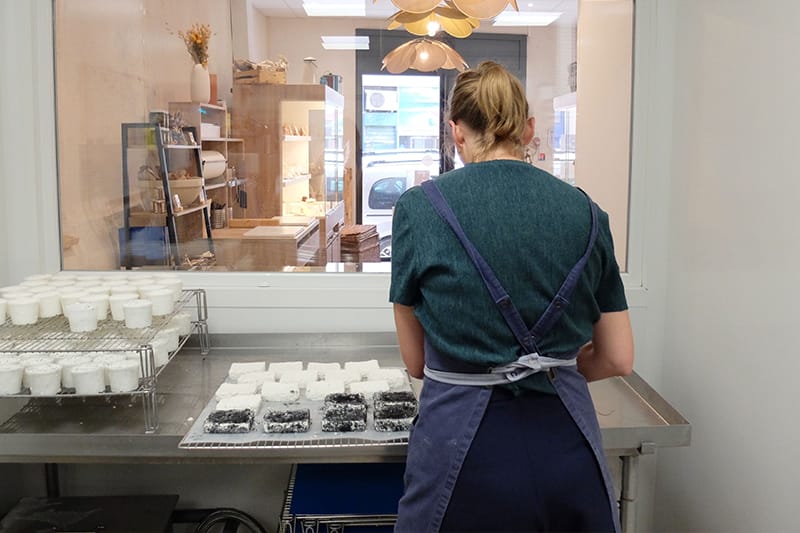A glass window bisects the shop and atelier, allowing customers to witness workmanship firsthand, photo by Alexis Steinman