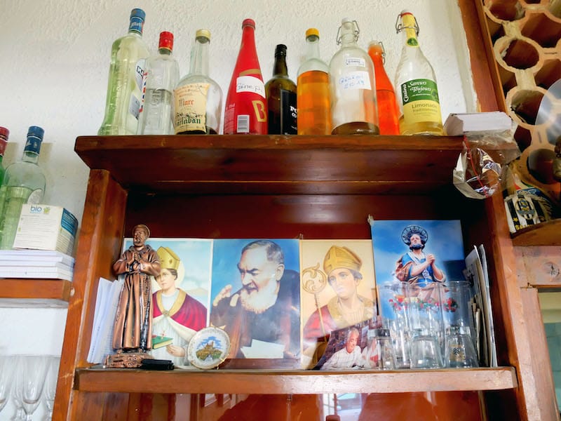 Salvatore's collection of saints and bottles of Italian digestifs at Le Vésuvio in Marseille, photo by Alexis Steinman