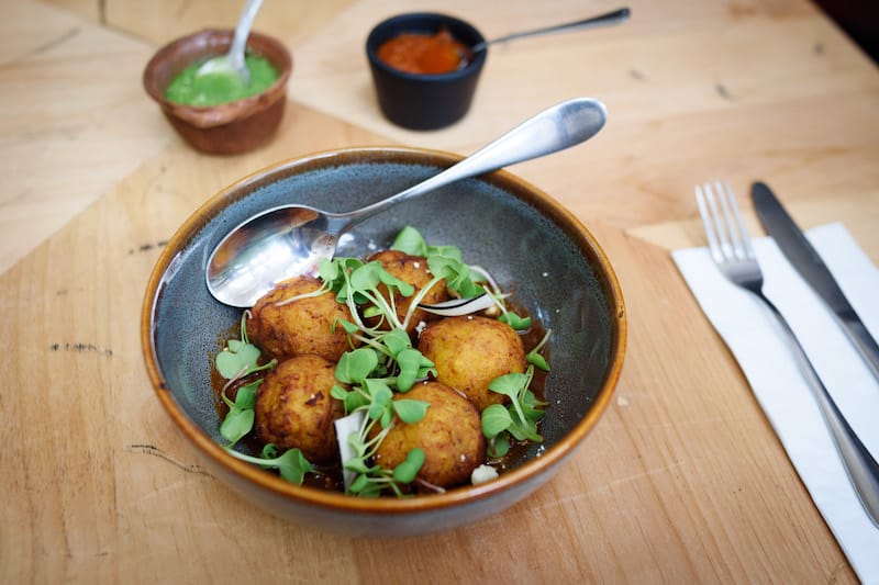 Pasillo de Humo’s molotes istemeños (cheese-stuffed sweet plantain) in red mole, photo by PJ Rountree