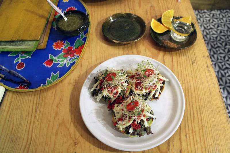 The tostada appetizer, alongside a mezcal served with gusano (worm) salt and an orange slice, photo by Martha Pskowski