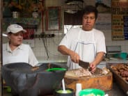 At El Charro Carnitas, you choose your cut of pork (everything from snout to tail), which is sliced and then served with lime and salsas.