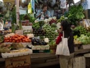 Elevated market stalls selling fresh produce.