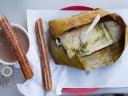 Tamales verdes with churros and champurrado (hot chocolate thickened with masa).