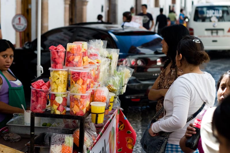Fruit vendor at Taxco market, photo by Ben Herrera
