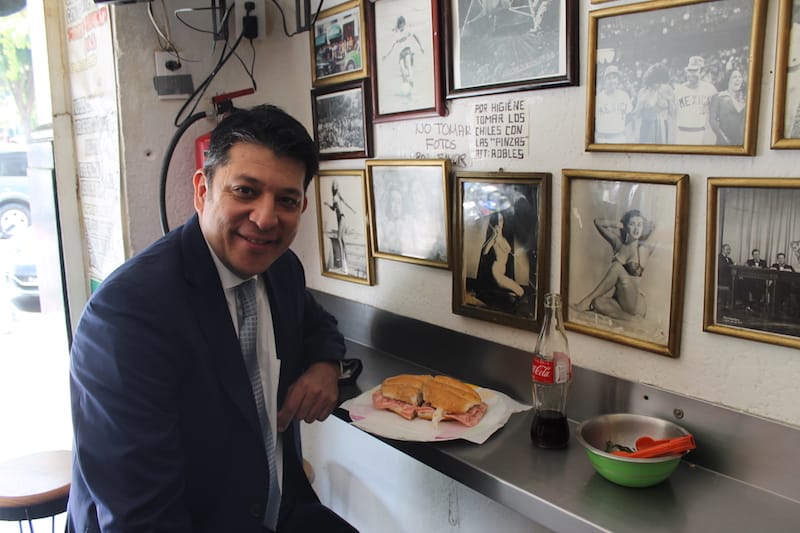 A customer about to dig into a ham torta at Tortas Robles, photo by Martha Pskowski torta Centro Histórico