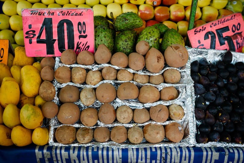 A chicozapote display in a Mexico City street market, photo by PJ Rountree